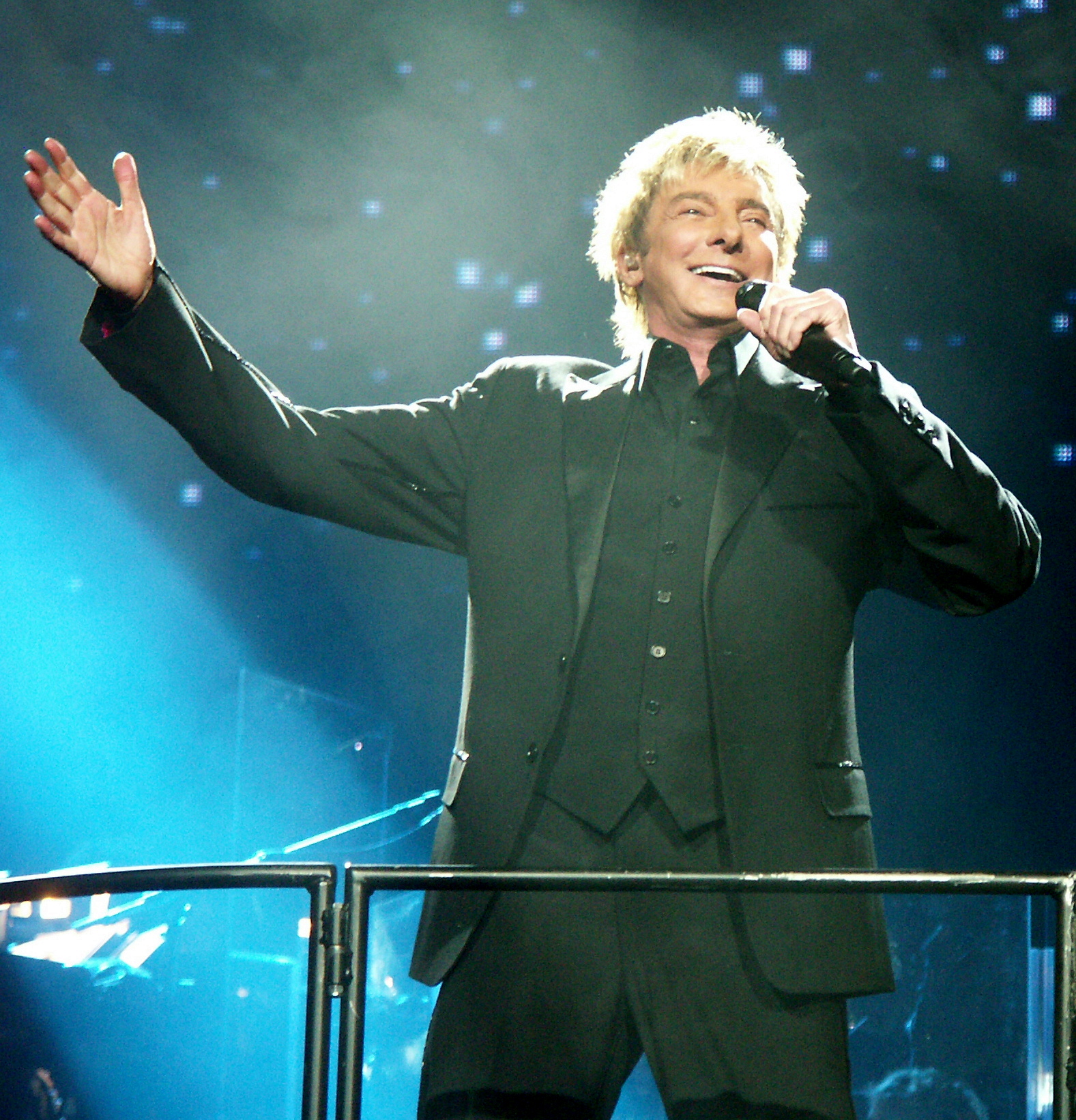 Barry Manilow performing onstage with a microphone