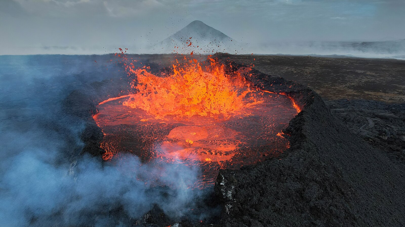 Bright orange lava erupting near Litli-Hrútur in Iceland in July 2023