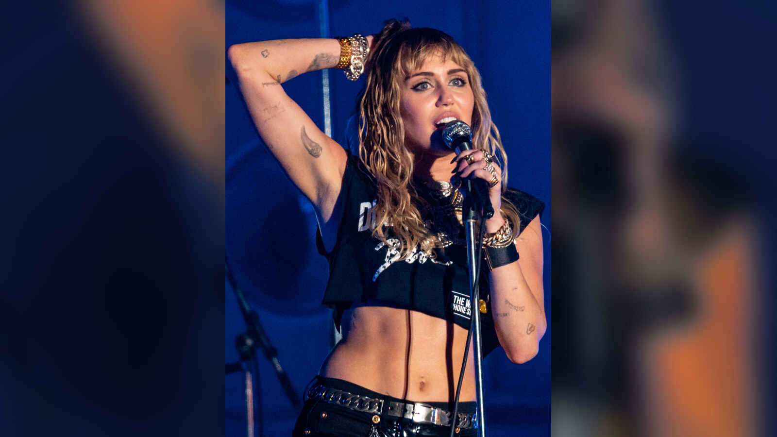 Miley Cyrus performing onstage with a microphone at Primavera Sound in 2019