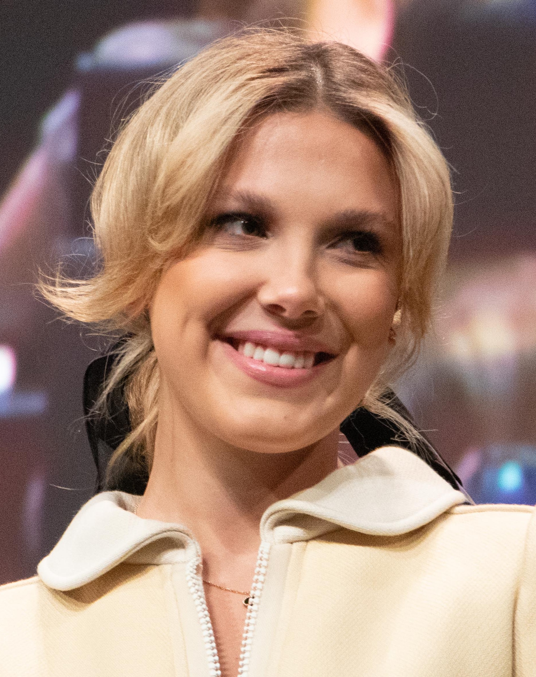 Millie Bobby Brown smiling at a 2022 fan convention