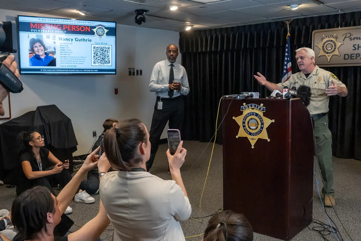 Missing-person poster for Nancy Guthrie displayed during a Pima County law-enforcement briefing