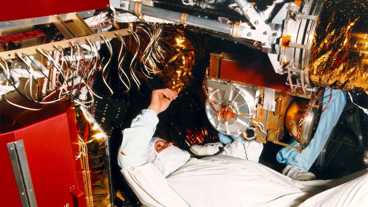 Representative view of technicians working on a spacecraft