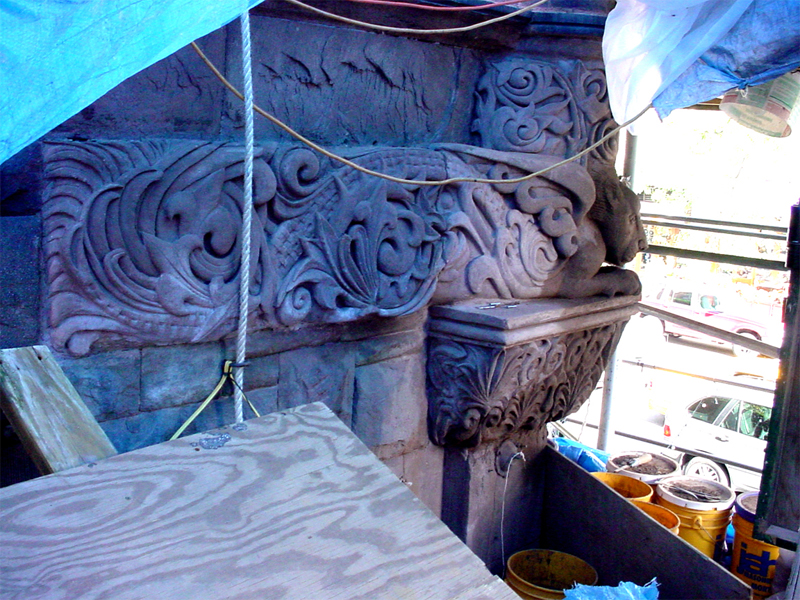 Stone winged gargoyle sculpture on a New York City building