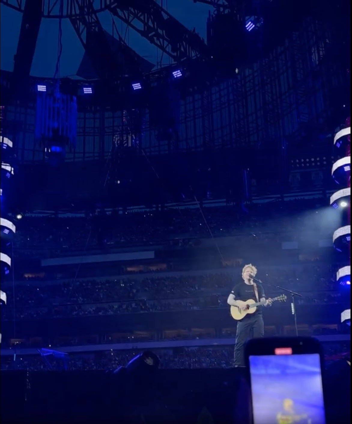 Ed Sheeran performing live onstage with an acoustic guitar in Philadelphia
