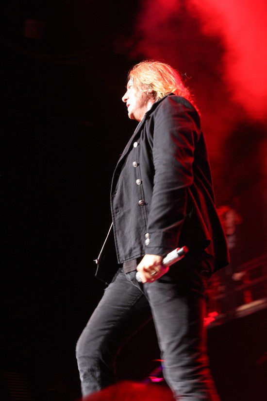 Def Leppard performing on a concert stage