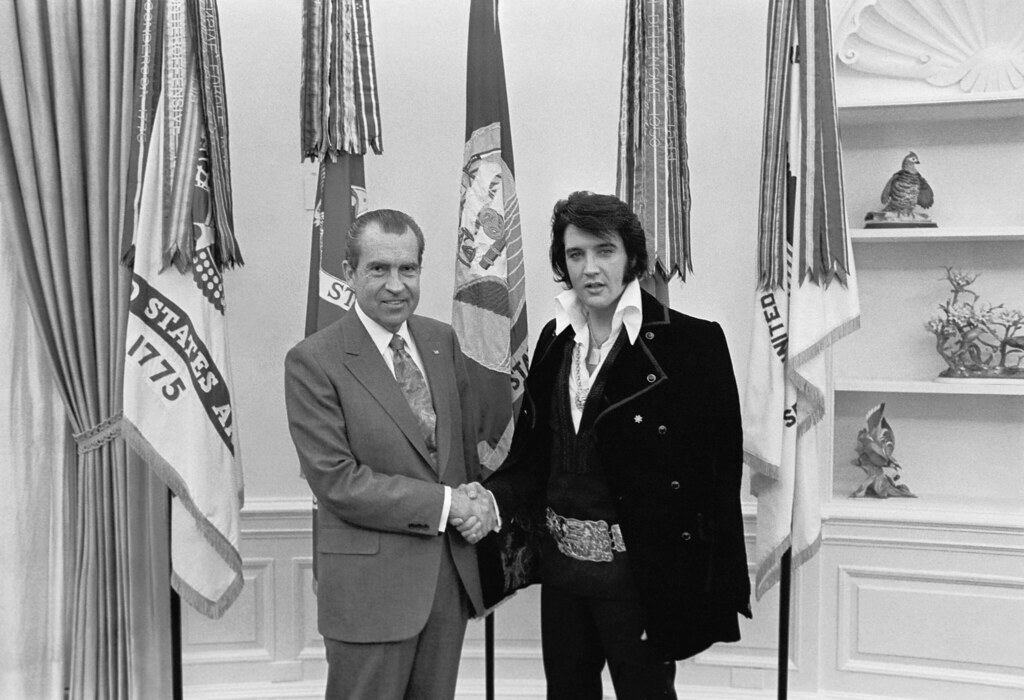 Historical photograph of Richard Nixon, left, shaking hands with Elvis Presley in the Oval Office on December 21, 1970.