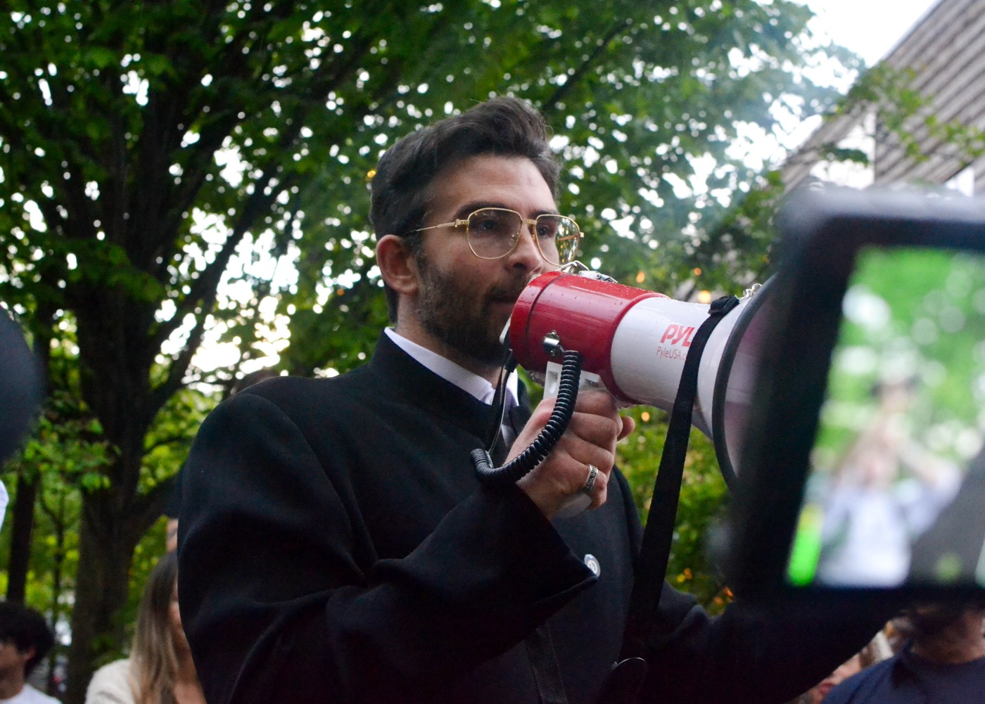 File photo of Hasan Piker speaking through a megaphone at a Chris Rabb campaign rally in Philadelphia on April 30, 2026.