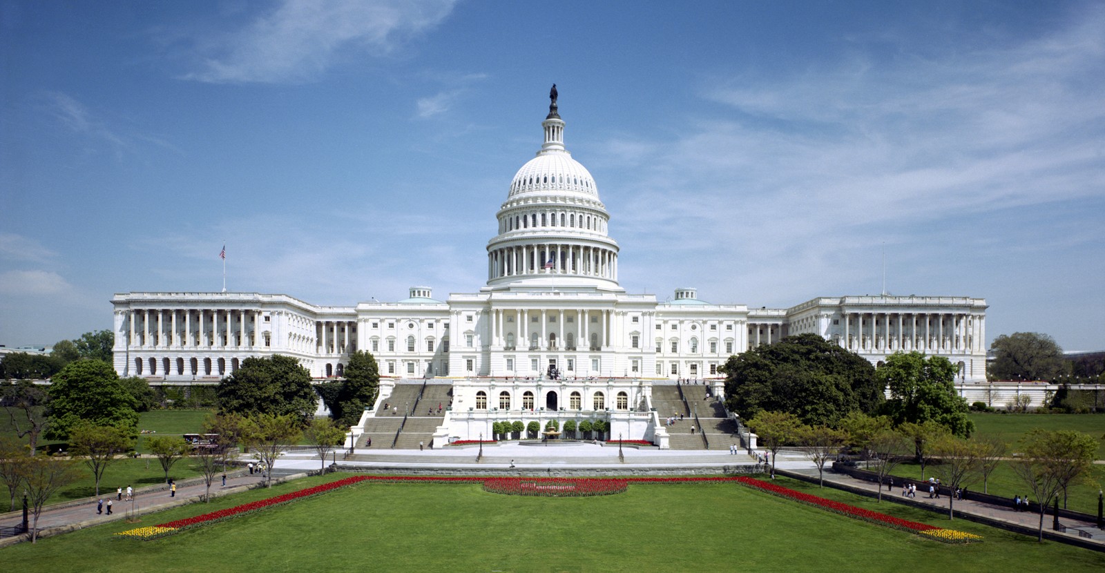 United States Capitol west front beneath a cloudy blue sky