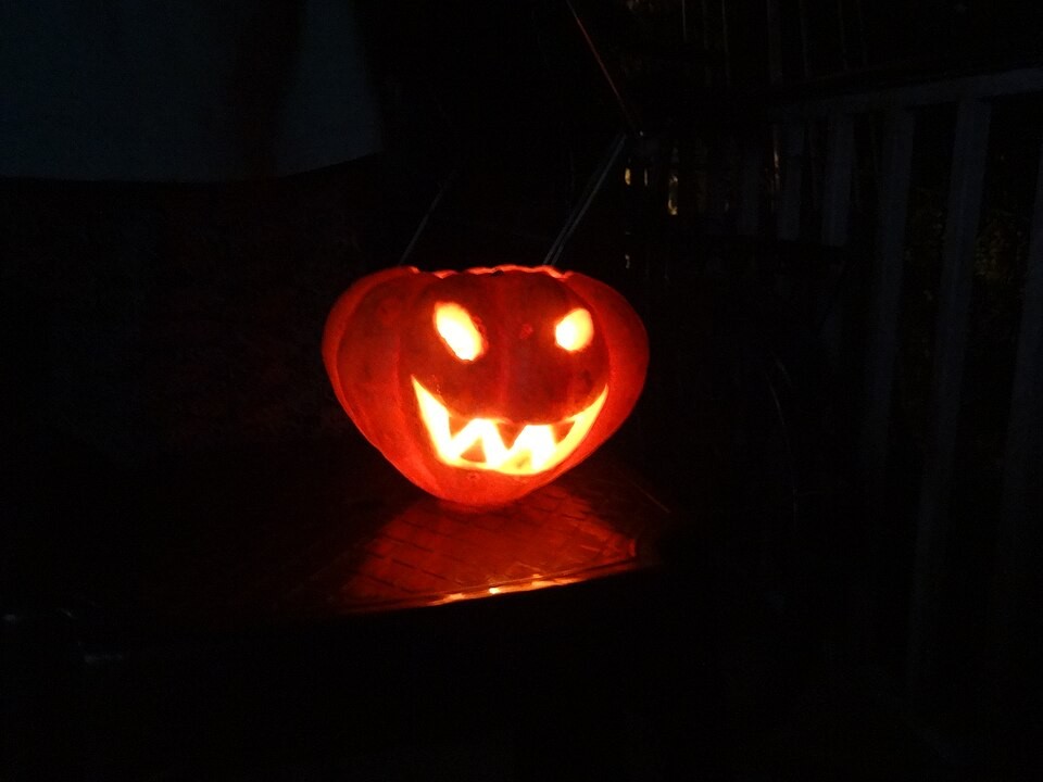 A carved jack-o’-lantern with a triangular-eyed face